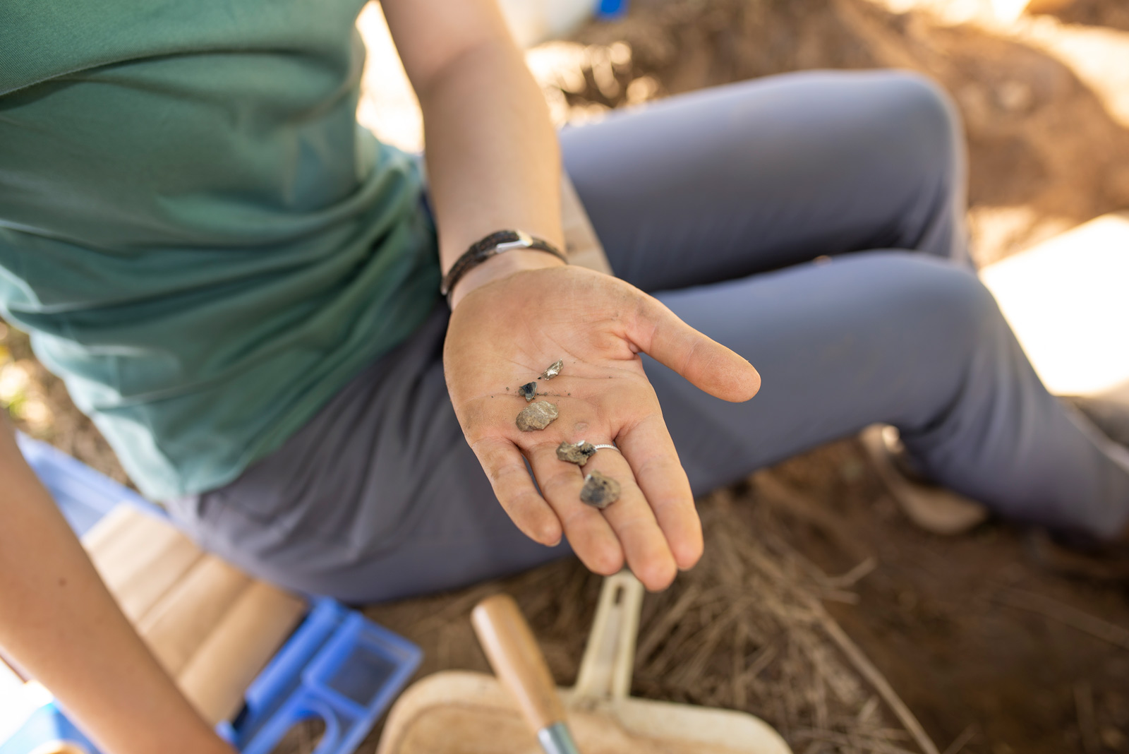 A researcher holds up ancient burned bone fragments