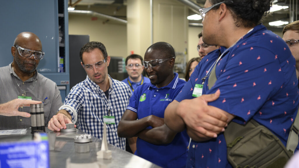 4 Men Looking Enthusiastically at Science Equipment