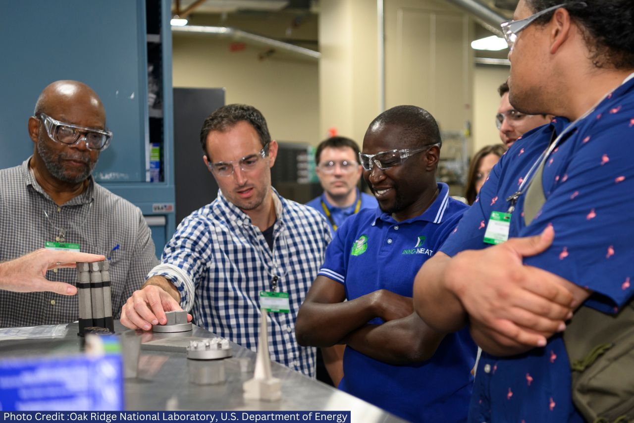 4 Men Looking Enthusiastically at Science Equipment
