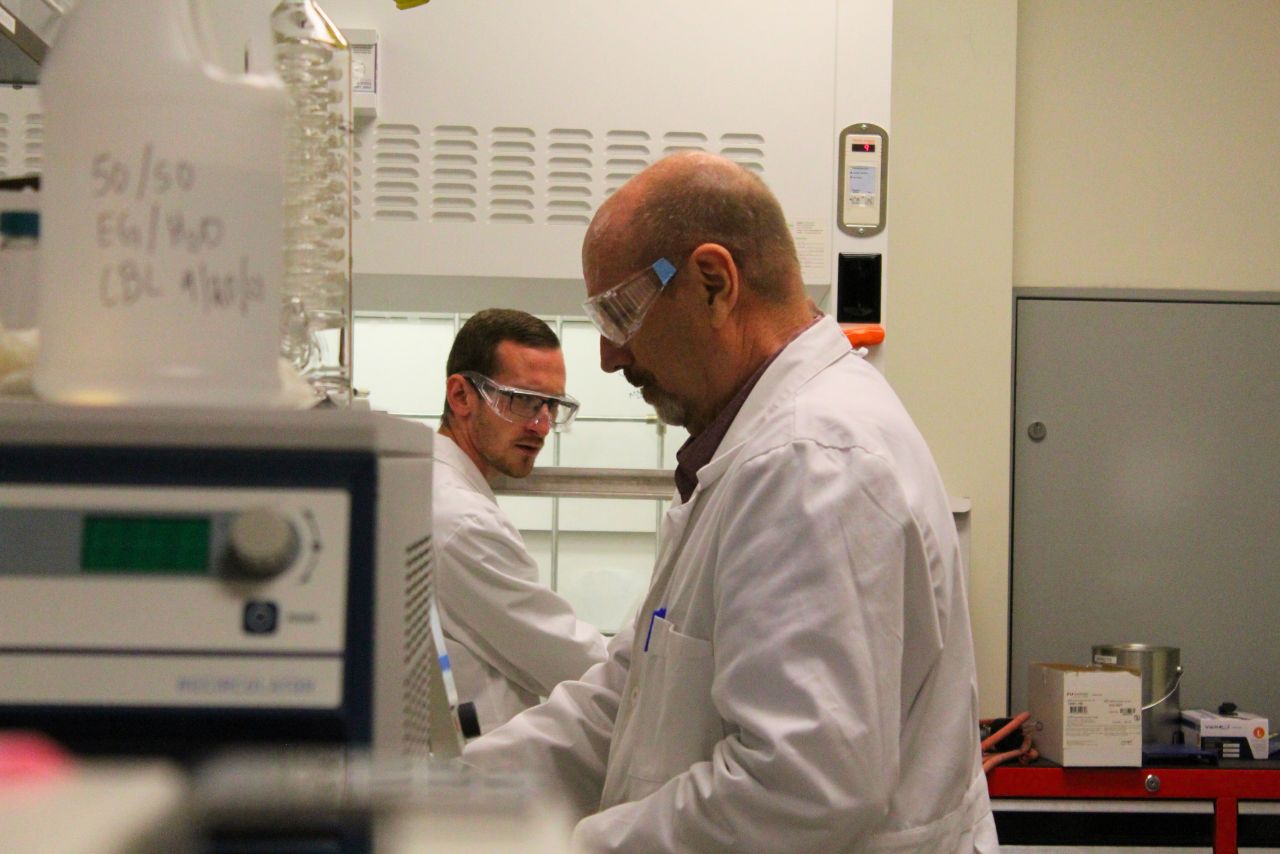 Anna Klug works on lab equipment with multiple monitors.
